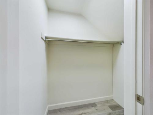 Apartments  for rent in Encino Empty white closet with a single metal clothes rod, light-colored flooring, and sloped ceiling. White Oak Apartments in Encino 5465 White Oak Avenue Encino, CA 91316  P: 866-471-5691 TTY: 711 F: 818-647-0393